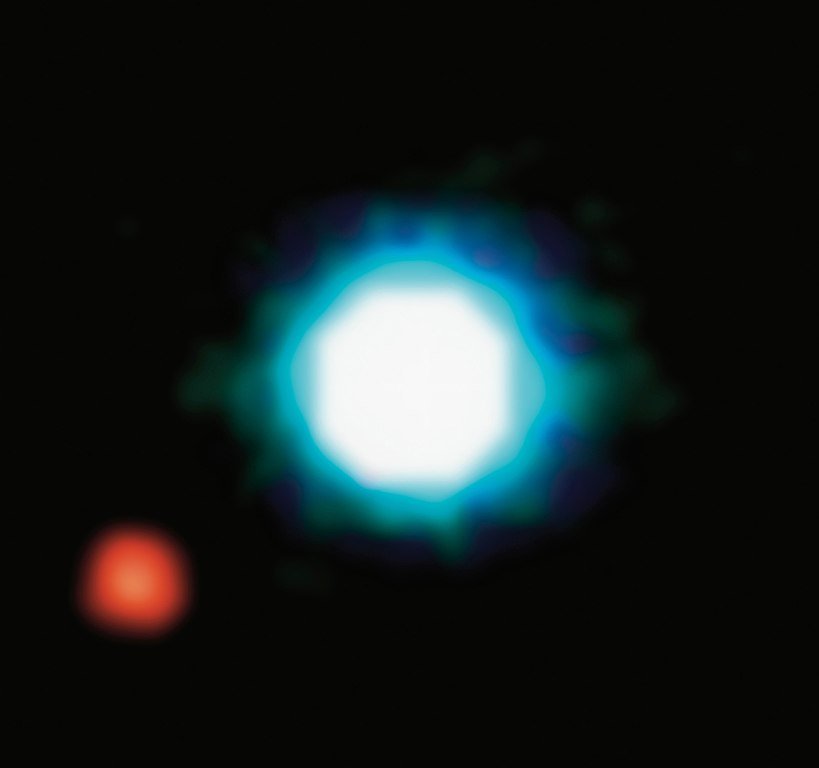European Southern Observatory infrared image of 2M1207 (bluish) and companion planet 2M1207b (reddish), taken in 2004.